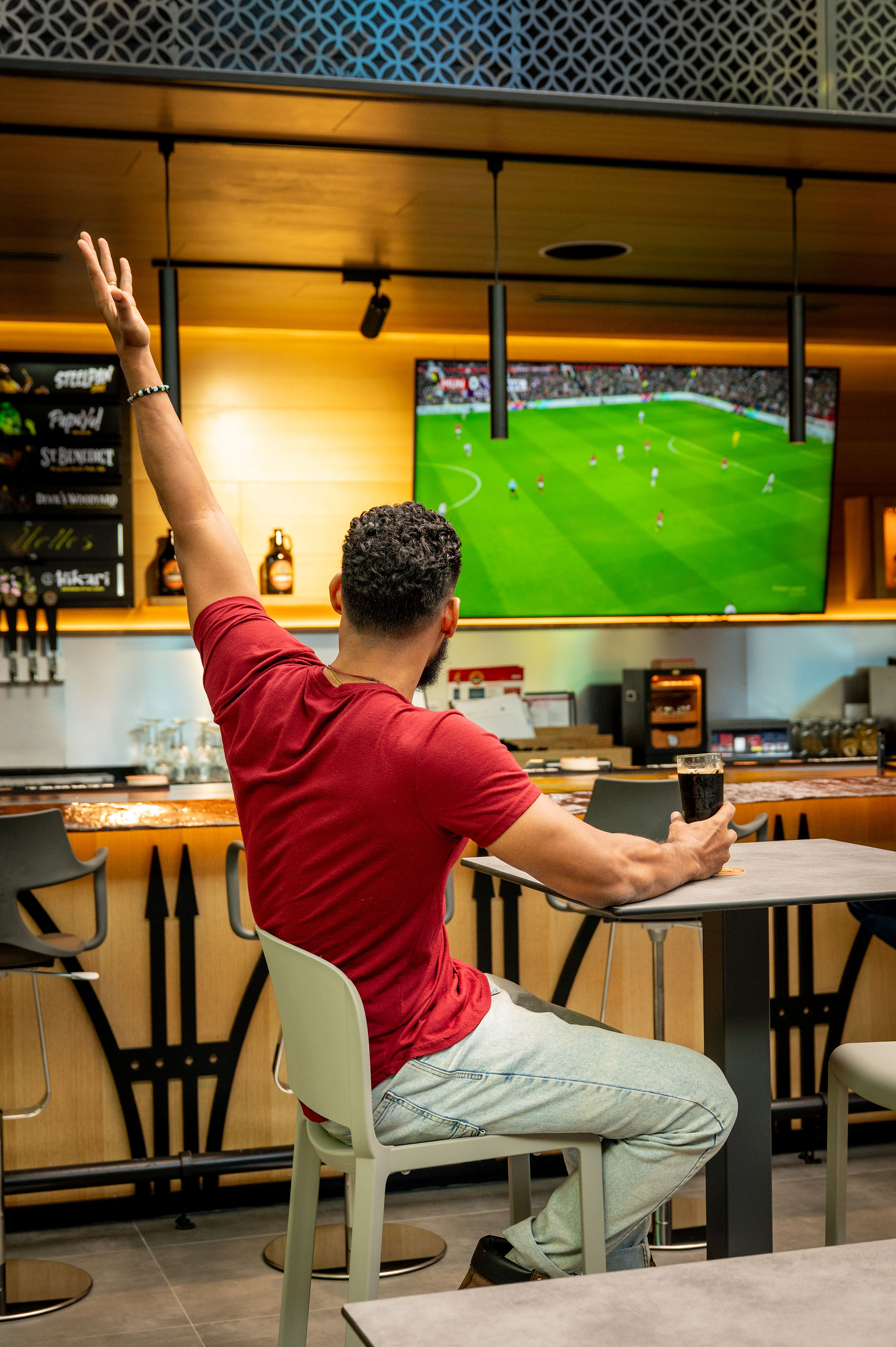 Guest watching football at Tommy's Brewing